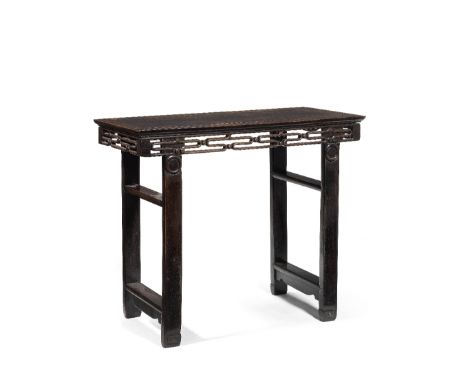 A HONGMU TABLEFirst half 20th centuryWith central inset panel, above carved reticulated scrollwork and beaded aprons, the leg