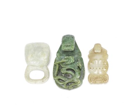 TWO JADE BELT HOOKS AND A JADE BUCKLE18th/19th CenturyComprising: a spinach jade chi dragon carving, with coiled dragon carve