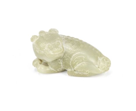 A PALE CELADON JADE CARVING OF A LUDUAN17th centurySeated with the legs tucked beneath and the head turned to the left, the b