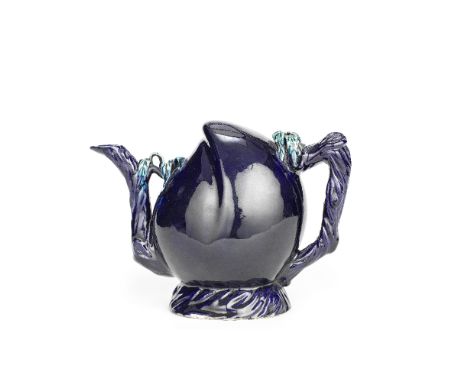 A LARGE AUBERGINE-GLAZED CADOGAN TEAPOTKangxiThe well-modelled peach shaped-vessel resting on a spreading foot, naturalistica