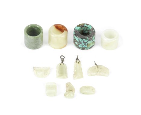 FOUR ARCHER'S RINGS AND SEVEN SMALL JADE CARVINGS19th centuryComprising: a white jade ring with incised C-scroll patterns; a 