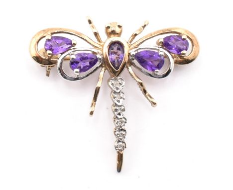 A hallmarked 9ct gold, amethyst and diamond dragonfly brooch pin. The 9ct yellow gold brooch pin in the form of a dragonfly s