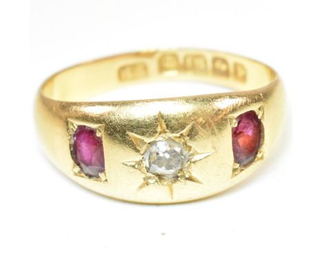 A hallmarked 18ct gold, diamond and ruby gypsy ring. The 18ct yellow gold ring having a central star set old cut diamond flan