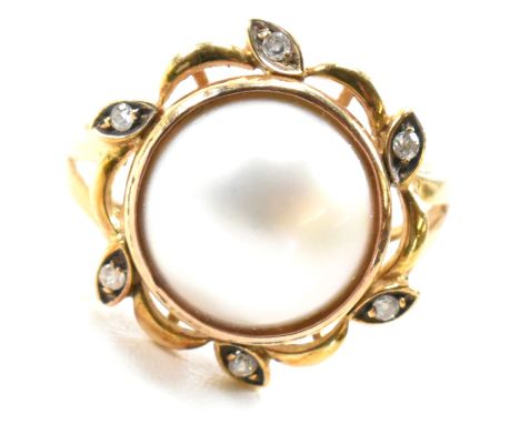 A mabe pearl and diamond flower halo ring. Marked 750, tests indicate 18ct gold. Weight 3.7g. Size O. All weights, measuremen