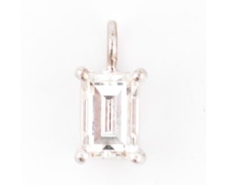 An 18ct white gold and diamond necklace pendant. The 18ct white gold necklace pendant having a four claw set step-cut diamond
