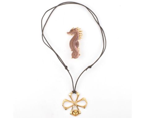 A Lalique gold tone metal pendant necklace and a Lalique seahorse brooch pin. The lot to include a Lalique yellow tone metal 