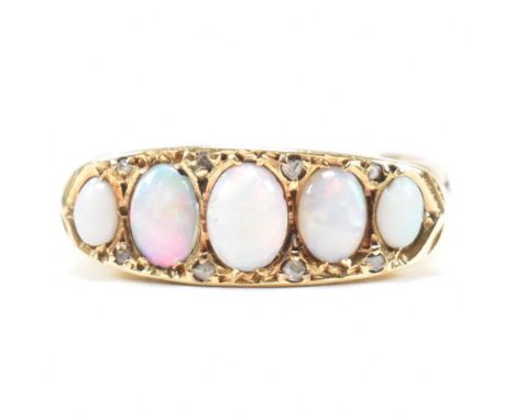 An early 20th century hallmarked 18ct gold and opal and diamond five stone ring. The antique ring having five graduating cabo