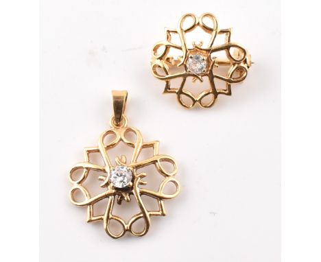 A 9ct gold and white stone necklace pendant and brooch pin suite. The 9ct yellow gold jewellery to include a pierced necklace