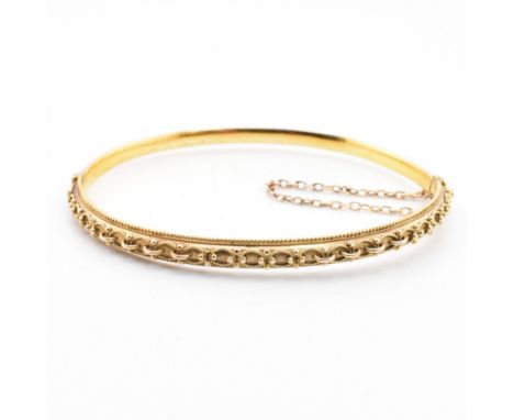 A Victorian hallmarked 15ct gold hinged bangle in original box. The Victorian 15ct gold bangle having intricate metal bead-wo