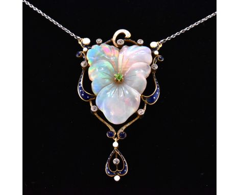 An early 20th century carved opal, diamond, garnet, pearl and enamel necklace. The necklace having a carved opal flower set w