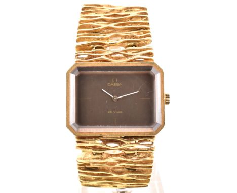 A 1970s Omega De Ville 8272 18ct gold wristwatch by Gilbert Albert. The watch having a naturalistic strap with fold-over snap