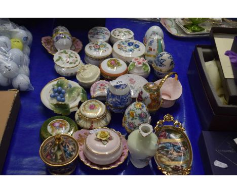 Collection of various porcelain trinket boxes and egg shaped ornaments