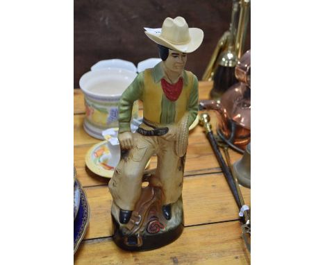 A regal china spirit flask modelled as a cowboy, 36cm high