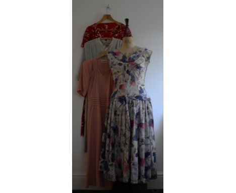 Four vintage1940s/1950s dresses. A 50s cotton print dress with full skirt, 28 inch waist, a 40s volup red/white print dress, 