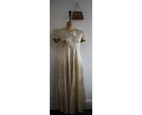 Two 1930s items. A 1930s pale gold dress with playing card motif print of spades, hearts, diamonds and clubs. 28 inch waist. 