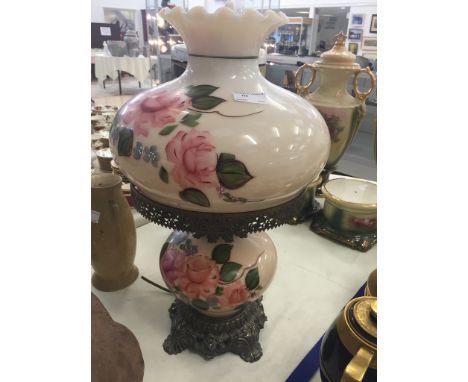A glass painted oil lamp