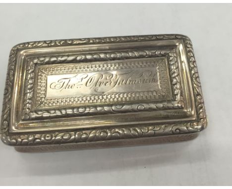 A Victorian silver snuff box: ornate and waisted form, floral scroll and engine turned: gilt interior: Birmingham 1849: maker