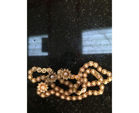 A vintage gold and pearl necklace interspersed with pearl set floral links