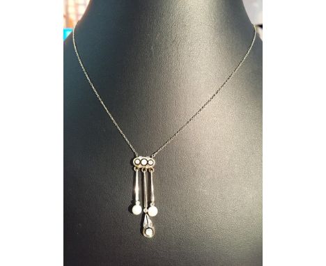 An Edwardian diamond and pearl drop necklace with diamond set pendants,on fine chain with box catch to the necklace