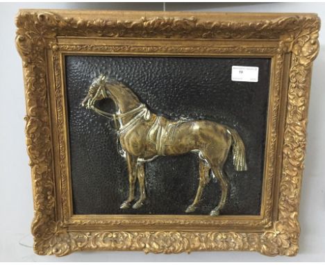 A brass relief plaque of a horse portrait