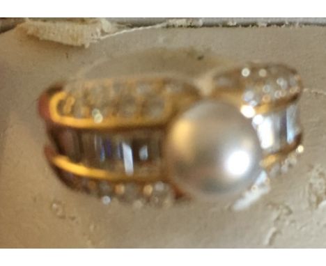 A boxed Cartier diamond and pearl ring, full Cartier marks set with brilliant and baguette diamonds