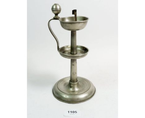 A 19th century primitive pewter oil lamp with wick holder, 23cm tall