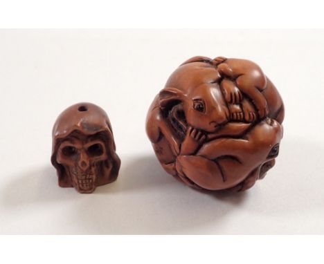 A Japanese carved wood rabbit netsuke and a similar small skull 