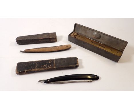 A brass spirit level and two cut throat razors in metal box 