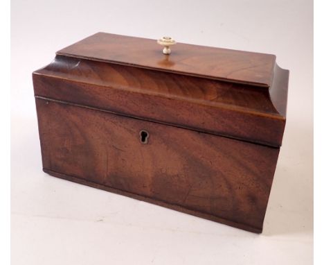 A George III mahogany tea caddy with bone finial and three interior caddies, 24cm wide 