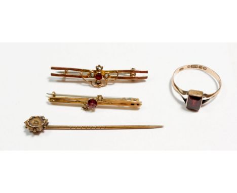 A 15 carat gold stick pin set chip diamond, two 9 carat gold bar brooches and a 9 carat gold garnet ring, total weight 5.6g 