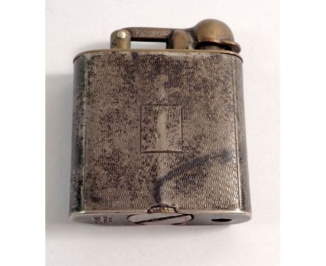 A silver engine turned cigarette lighter 