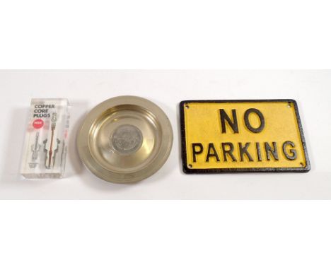 A Silverstone commemorative dish, a Copper Core NGK spark plug perspex promotional item and a No Parking sign 