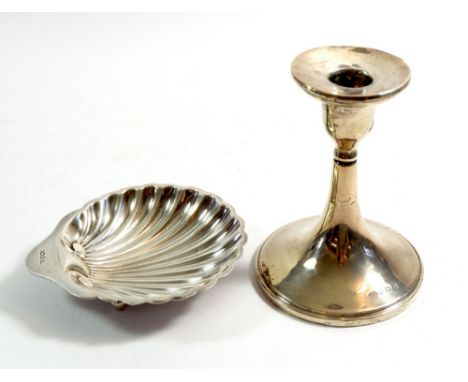 A silver shell butter dish, Sheffield 1910 by Harrison Brothers &amp; Howson, 60g and a silver candlestick, Birmingham 1923 b