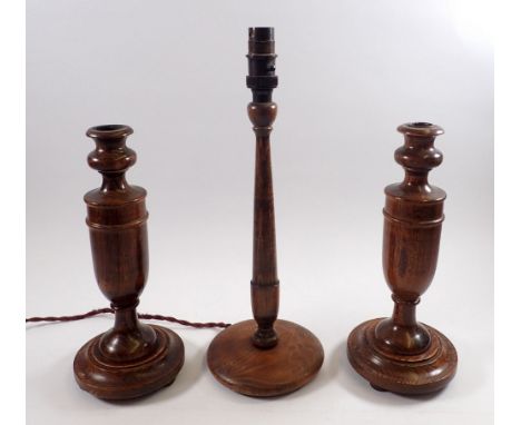 A pair of oak candlesticks, 29cm tall and a turned wood table lamp, 38cm tall 