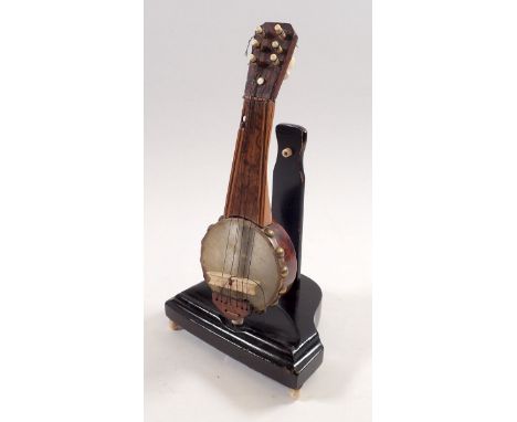 A miniature walnut model of a banjo with bone mounts, 19cm tall 