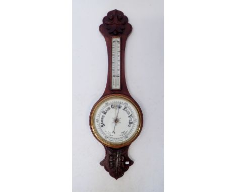 An oak aneroid  barometer/thermometer 