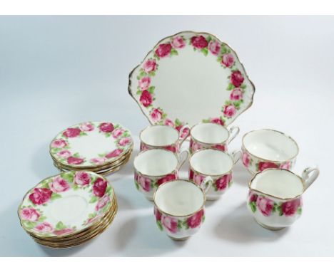A Royal Albert Old English Rose tea service including five cups and saucers, six side plates, one cake plate, milk and sugar 