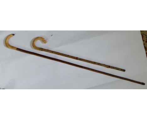 A horn handled walking stick and similar staff 