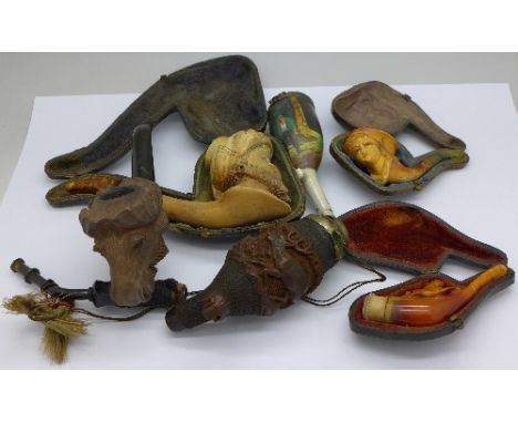 Three Meerschaum pipes, two carved pipes and an Austrian painted pipe