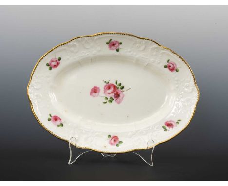 NANTGARW PORCELAIN OVAL DISH circa 1818-1820, typically moulded with c-scrolls and flowers, painted with roses, impressed mar