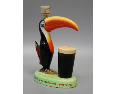 Carlton Ware Limited, a mid 20th century Guiness promotional table lamp, modelled with a toucan and pint of stout, on an oval