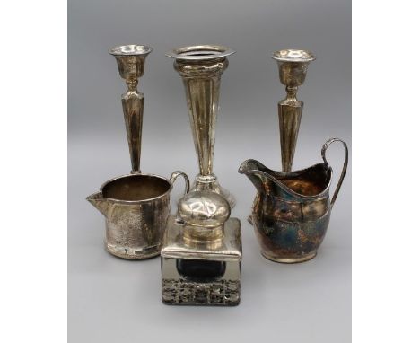 Henry Wilkinson Ltd, a pair of George V silver candlesticks of square tapering form on a spreading foot, Birmingham 1925, 18c