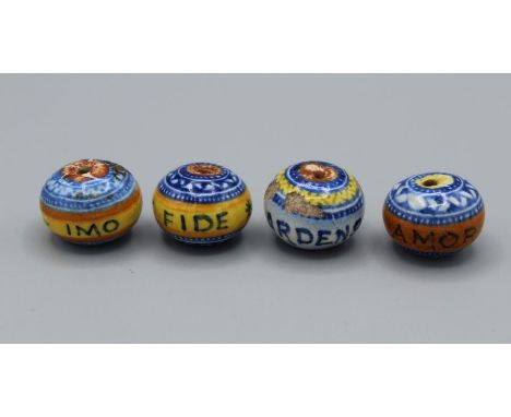A set of four continental 19th century ceramic beads with different Latin phrases - "Amor Regnant"; "Ignis Ardens" "Imo Pecto