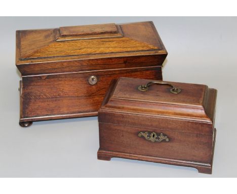 A Victorian rosewood tea caddy of sarcophagus form with vacant three division interior on four bun feet, 33cm wide, together 