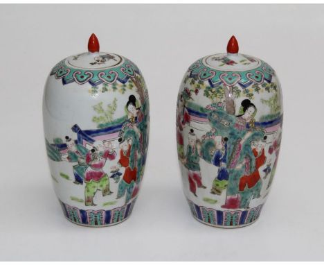 A pair of Chinese Famille Rose covered vases of shouldered cylindrical tapering form, each decorated with figures in a landsc