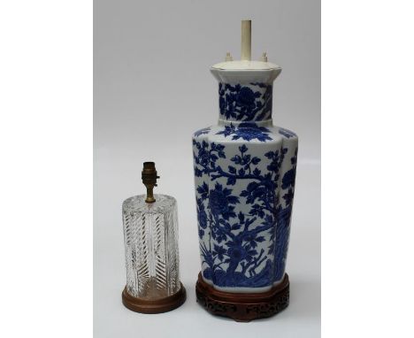 An early 20th century table lamp of quatrefoil form, decorated with peonies in the Oriental manner, on pierced hardwood stand