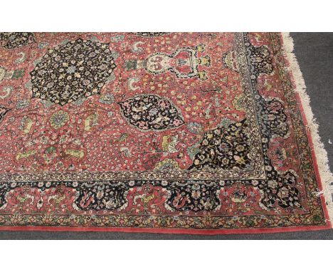 A 20th century Sparta type carpet, woven with bold central floral medallion, on a principally light madder ground with palmet