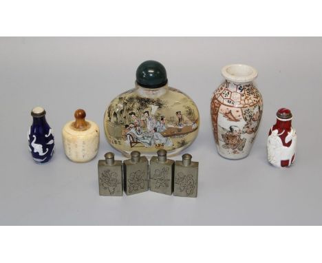 A large 20th century Chinese glass snuff bottle painted with figures in a landscape, 10.5cm, together with a four division wh