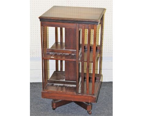 An early 20th century mahogany bookcase of two tiers with slatted sides, on quatrefoil base and ceramic castors, 85 x 47cm