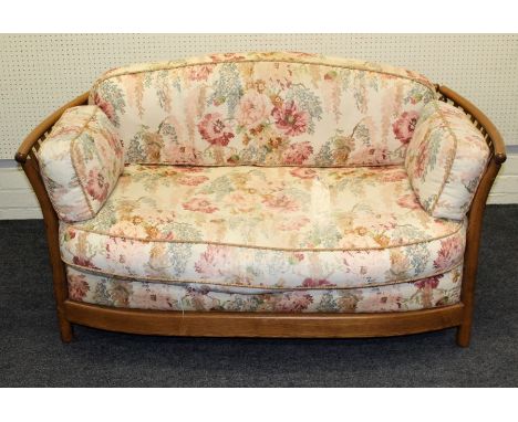 An Ercol light elm, two person, conservatory settee, design number 10692, with lathe splats on turned stile supports. 150 x 1